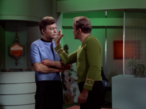 Kirk slaps Bones condescendingly 