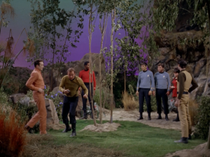 Kirk karate chops a lady and makes a break for it, but they freeze him