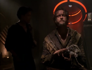 Kim has to team up with a crazy guy because he had stuff Kim needed. The crazy guy says he thinks the clamp is meant to keep people from cooperating with each other, because if the prisoners work together they could get out.