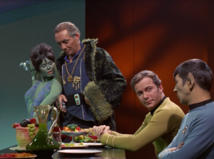 He tries to get the Orion lady to seduce Kirk with her dancing