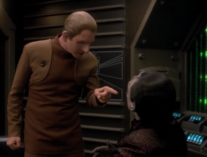 Odo figures out that Garak blew up his own shop to get Odo to help him out