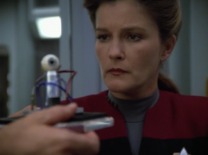 The Doctor helps Janeway set up her webcam 