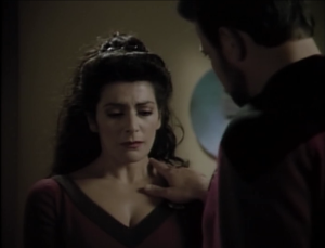 Riker touches her shoulder