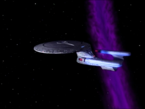 The particles are pulling Enterprise into a cosmic string. It will destroy them!